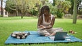 African american woman student using laptop taking notes at campus university Royalty Free Stock Photo