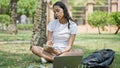 African american woman student using laptop taking notes at university campus Royalty Free Stock Photo