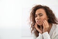 African-American woman suffering from tooth ache on light background. Royalty Free Stock Photo