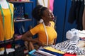 African american woman tailor stressed using sewing machine at sewing studio Royalty Free Stock Photo