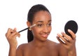 African american woman using eye shadow brush