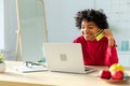 African american woman using laptop shopping online paying with gold credit card. Girl sitting at home buying on Royalty Free Stock Photo