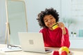 African american woman using laptop shopping online paying with gold credit card. Girl sitting at home buying on Royalty Free Stock Photo