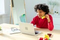 African american woman using laptop shopping online paying with gold credit card. Girl sitting at home buying on Royalty Free Stock Photo