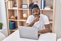 African american woman using laptop sitting on table at home Royalty Free Stock Photo