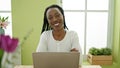 African american woman using laptop sitting on table at home Royalty Free Stock Photo