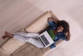 African American woman using laptop on sofa top view Royalty Free Stock Photo