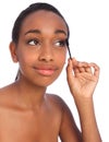 African American woman using mascara brush