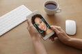 African-American woman using smartphone with facial recognition system at table. Biometric verification Royalty Free Stock Photo