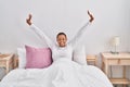 African american woman waking up stretching arms at bedroom Royalty Free Stock Photo