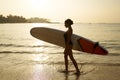 African american woman walking with surfboard on ocean beach. Black female surfer posing with surf board. Pretty Royalty Free Stock Photo