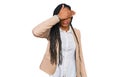 African american woman wearing business jacket covering eyes with hand, looking serious and sad Royalty Free Stock Photo