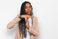 African american woman wearing business jacket doing time out gesture with hands, frustrated and serious face Royalty Free Stock Photo