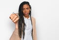 African american woman wearing business jacket looking unhappy and angry showing rejection and negative with thumbs down gesture Royalty Free Stock Photo