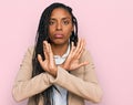 African american woman wearing business jacket rejection expression crossing arms doing negative sign, angry face Royalty Free Stock Photo