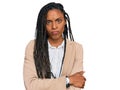 African american woman wearing business jacket skeptic and nervous, disapproving expression on face with crossed arms Royalty Free Stock Photo