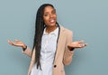 African american woman wearing business jacket smiling showing both hands open palms, presenting and advertising comparison and