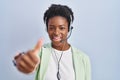 African american woman wearing call center agent headset approving doing positive gesture with hand, thumbs up smiling and happy Royalty Free Stock Photo