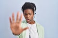 African american woman wearing call center agent headset doing stop gesture with hands palms, angry and frustration expression Royalty Free Stock Photo