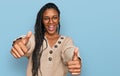 African american woman wearing casual clothes approving doing positive gesture with hand, thumbs up smiling and happy for success Royalty Free Stock Photo