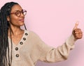 African american woman wearing casual clothes looking proud, smiling doing thumbs up gesture to the side Royalty Free Stock Photo