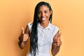 African american woman wearing casual clothes success sign doing positive gesture with hand, thumbs up smiling and happy Royalty Free Stock Photo
