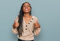 African american woman wearing casual clothes success sign doing positive gesture with hand, thumbs up smiling and happy Royalty Free Stock Photo