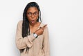 African american woman wearing casual clothes surprised pointing with finger to the side, open mouth amazed expression Royalty Free Stock Photo