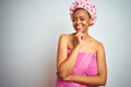 African american woman wearing pink shower towel after bath over isolated background looking confident at the camera smiling with Royalty Free Stock Photo