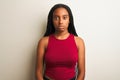 African american woman wearing red casual t-shirt standing over isolated white background with serious expression on face Royalty Free Stock Photo