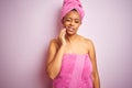 African american woman wearing shower towel after bath over pink isolated background touching mouth with hand with painful Royalty Free Stock Photo