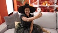 African american woman wearing witch costume make selfie by smartphone at home