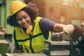 African American woman worker happy smiling working with metal machine in heavy industry factory Royalty Free Stock Photo