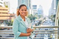 African American woman worker walks in a trendy business district with a tablet Royalty Free Stock Photo