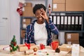 African american woman working at small business doing christmas decoration doing ok gesture with hand smiling, eye looking