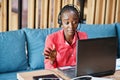 African american woman works in a call center operator and customer service agent wearing microphone headsets working on laptop