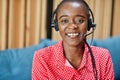 African american woman works in a call center operator and customer service agent wearing microphone headsets working on laptop