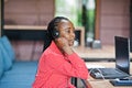 African american woman works in a call center operator and customer service agent wearing microphone headsets working on laptop