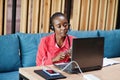 African american woman works in a call center operator and customer service agent wearing microphone headsets working on laptop