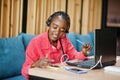 African american woman works in a call center operator and customer service agent wearing microphone headsets working on laptop