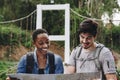 African American woman and a Caucasian man looking at a map together travel and teamwork concept Royalty Free Stock Photo