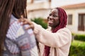 African american women friends standing together speaking at park Royalty Free Stock Photo