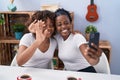 African american women mother and daughter having video call at home Royalty Free Stock Photo