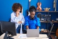 African american women musicians using laptop composing song at music studio