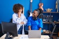 African american women musicians using laptop composing song at music studio