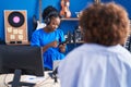 African american women musicians using smartphone at music studio