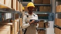 African american woman in overalls working with tablet