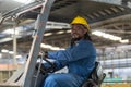 African american worker man wear safety helmet driver forklift warehouse in factory. Male worker industrial operate. control Royalty Free Stock Photo