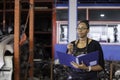 African american worker woman wear spectacles crossed arms holding clipboard standing in factory auto parts. female employee