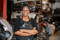 African american worker woman wear spectacles crossed arms standing in factory auto parts.